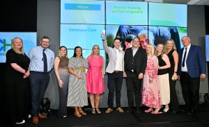 Group image of Sanctuary Care staff with their award