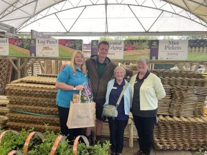 Image of Sharon Dewsbury and Phil Brown with Paternoster House volunteers Daphne and Carol Smith. All are smiling and stood in a community garden.